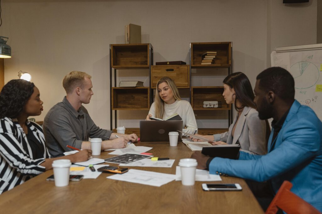 Business team discussing strategies in a modern office setting, focusing on collaboration.